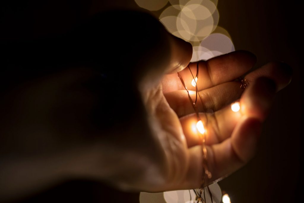 hand holding small lights